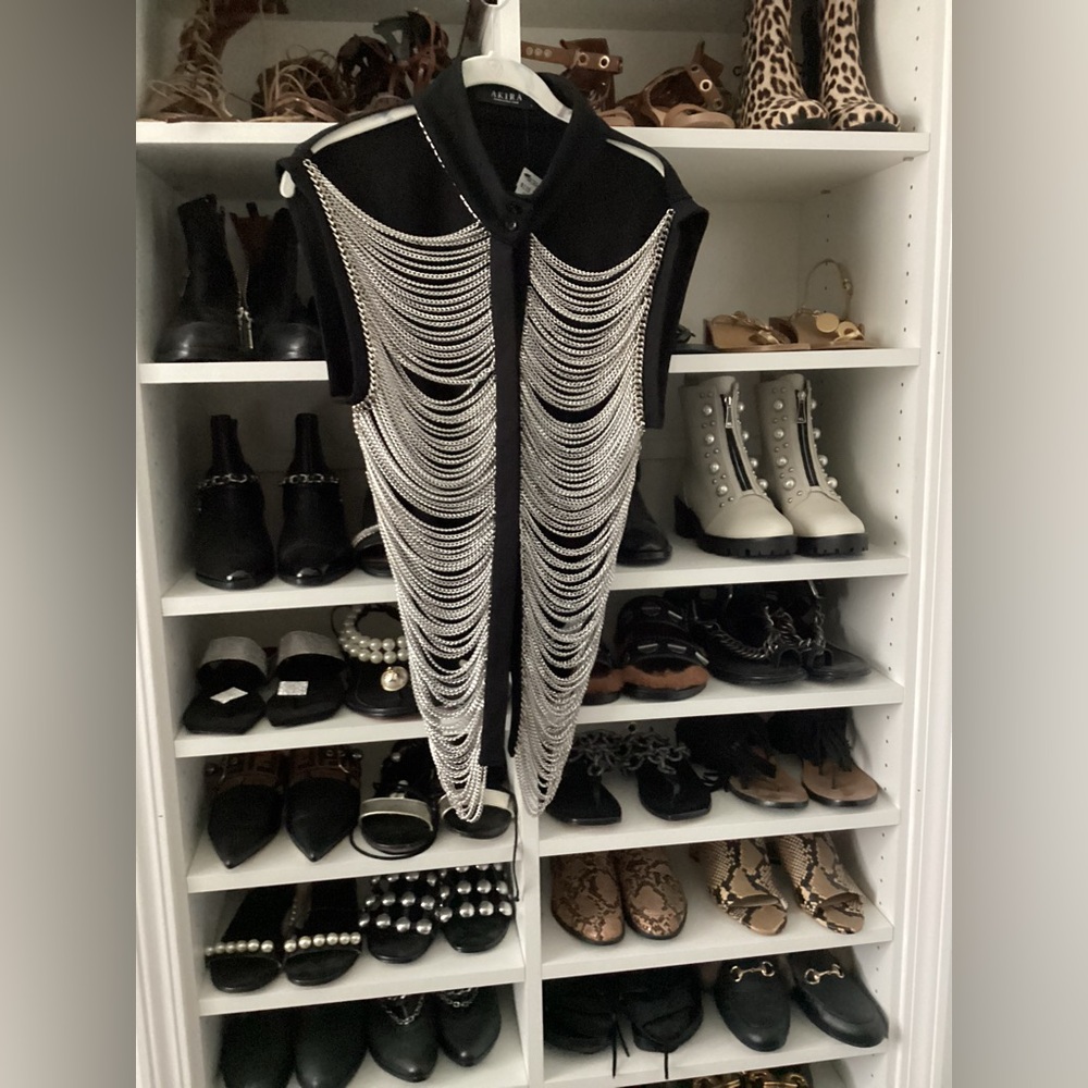 Sleeveless black top with silver chain